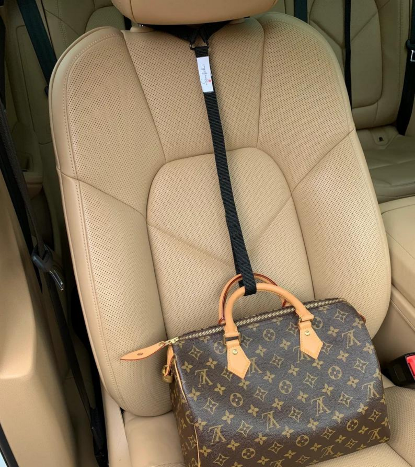 Stop the useless soccer mom arm move.   Get a Strap for that and prevent your passenger seat purse spills forever