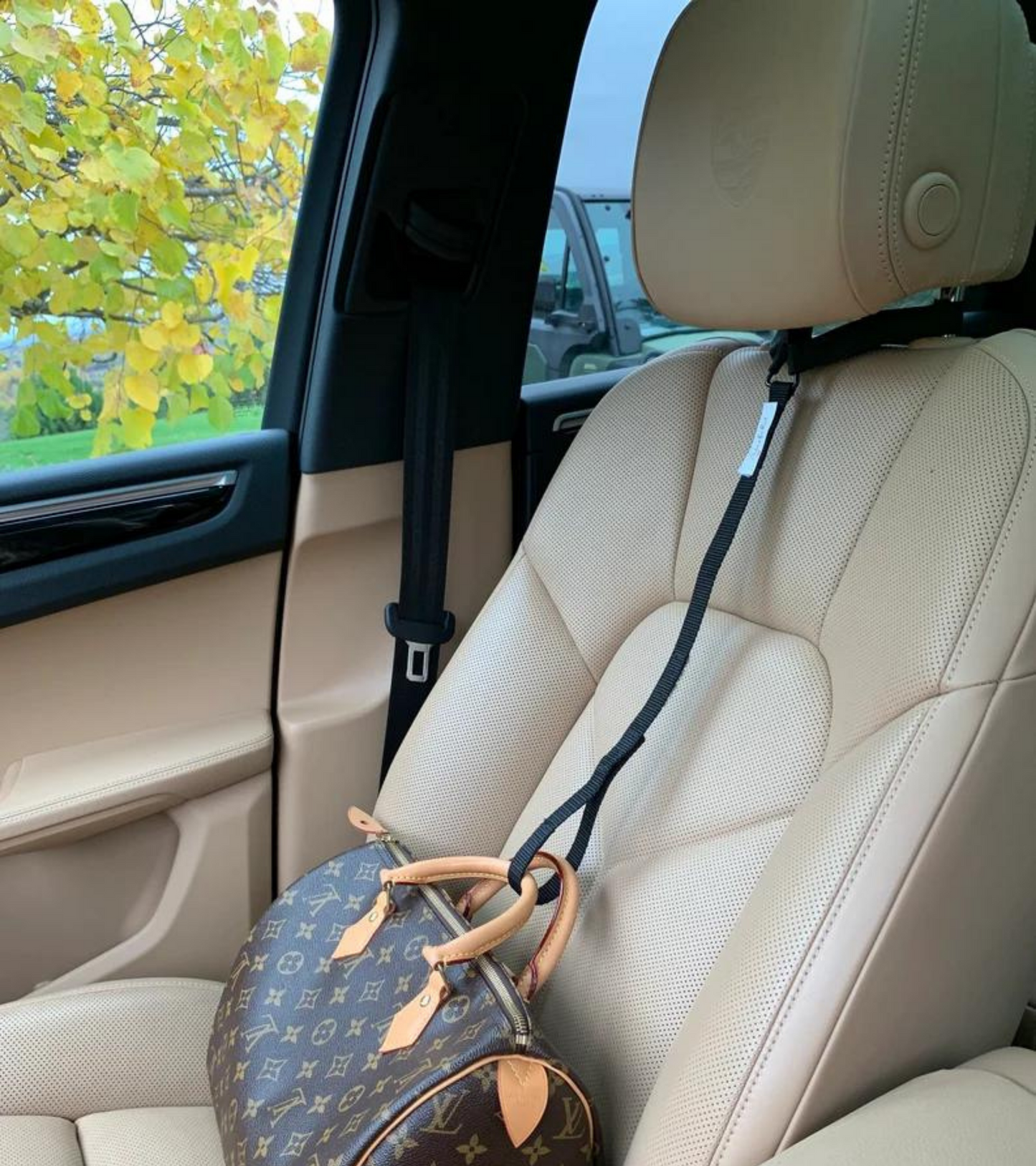 Stop the useless soccer mom arm move.   Get a Strap for that and prevent your passenger seat purse spills forever
